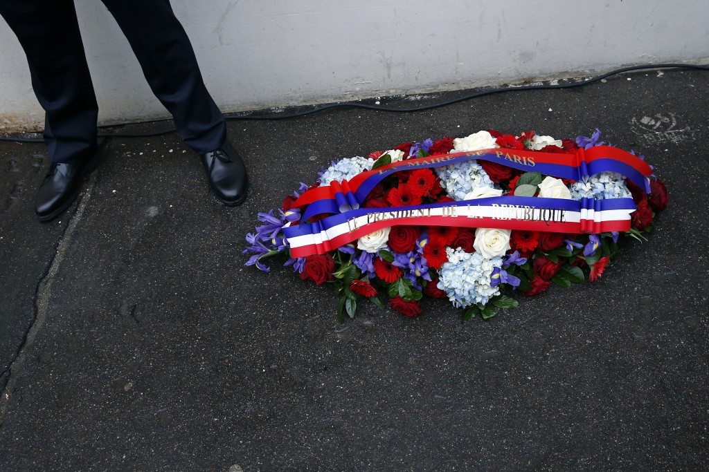 A wreath of flowers from the French President and Paris Mayor during a ceremony to pay tribute to the victims of last year's attacks outside the former offices of Charlie Hebdo. REUTERS/Benoit Tessier