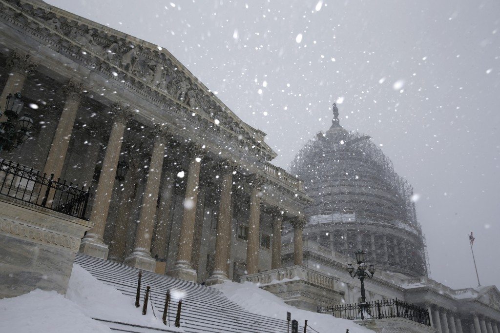 Snow falling outside the U.S. Capitol in Washington. A potentially record-breaking blizzard paralyzed road, rail and airline travel on the U.S. East Coast from North Carolina to New York.  REUTERS/Jonathan Ernst