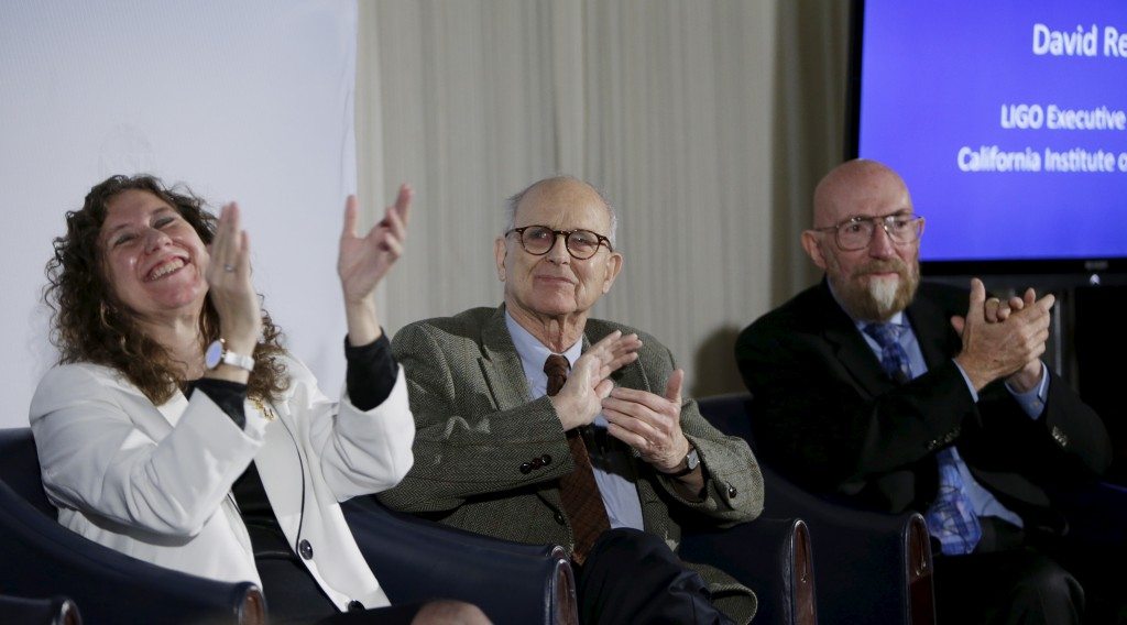 Doctors Gabriela Gonzalez, Rainer Weiss and Kip Thorne applaud the announcement of the detection of gravitational waves, ripples in space and time hypothesized by physicist Albert Einstein a century ago, in Washington. REUTERS/Gary Cameron - RTX26ITI