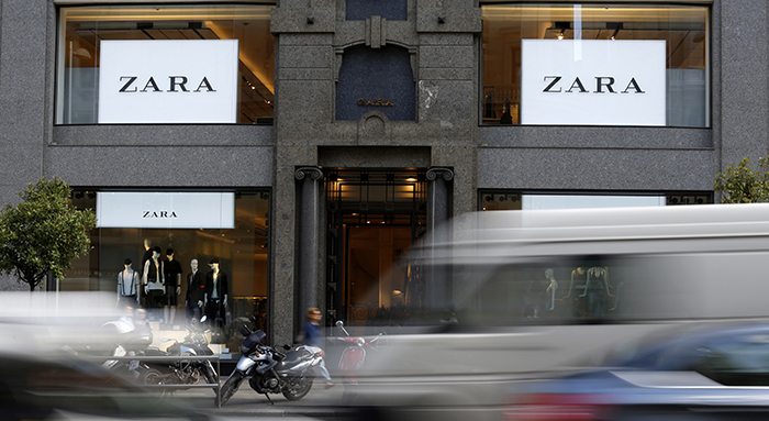 Cars pass in front of a Zara store in Madrid, Spain.