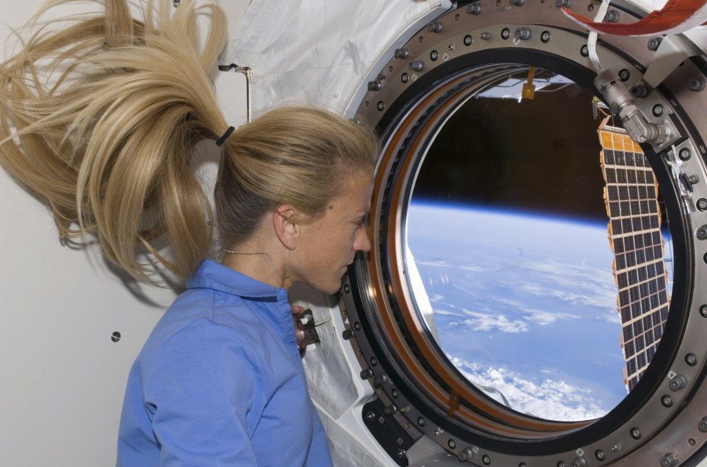 Astronaut Karen Nyberg looks through a window of the International Space Station. Released by NASA June 11, 2008.  REUTERS/NASA