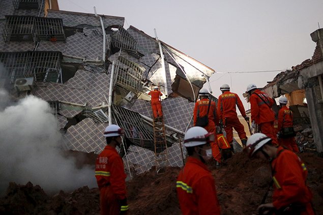 Firefighters search for survivors among the debris of collapsed buildings after a landslide hit an industrial park in Shenzhen, Guangdong province, China.
REUTERS/Tyrone Siu 