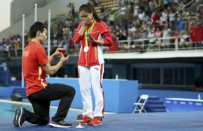 He Zi of China receives a marriage proposal from her boyfriend of six years, fellow diver Qin Kai, after her silver medal ceremony. Photo Reuters