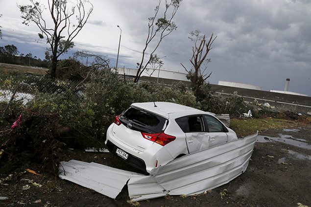 A car sits among factory roof debris with its windows smashed alongside an oil refinery following a rare tornado in the Sydney suburb of Kurnell.
REUTERS/Jason Reed
