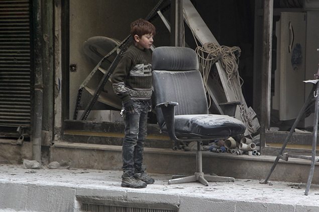 A boy inspects damage after airstrikes by pro-Syrian government forces in the rebel held Al-Shaar neighbourhood of Aleppo. REUTERS/Abdalrhman Ismail 