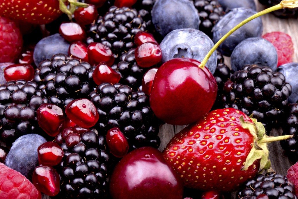 Tasty summer fruits on a wooden table