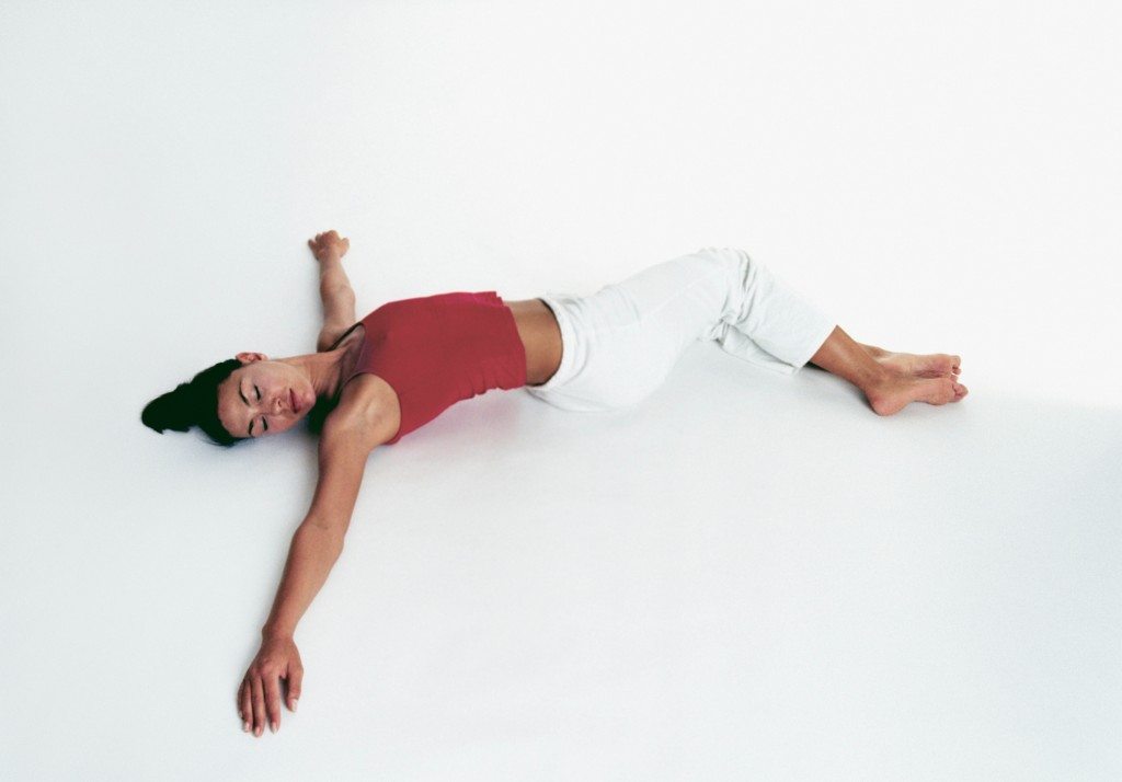 Woman in reclining twist yoga position