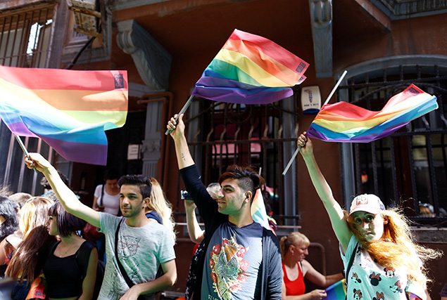 LGBT rights activists wave rainbow flags during a transgender pride parade which was banned by the governorship, in central Istanbul. REUTERS/Osman Orsal 