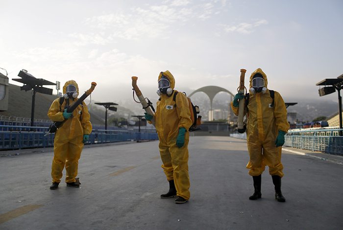 Municipal workers wait before spraying insecticide at Sambodrome in Rio de Janeiro. Photo: Pilar Olivares/REUTERS